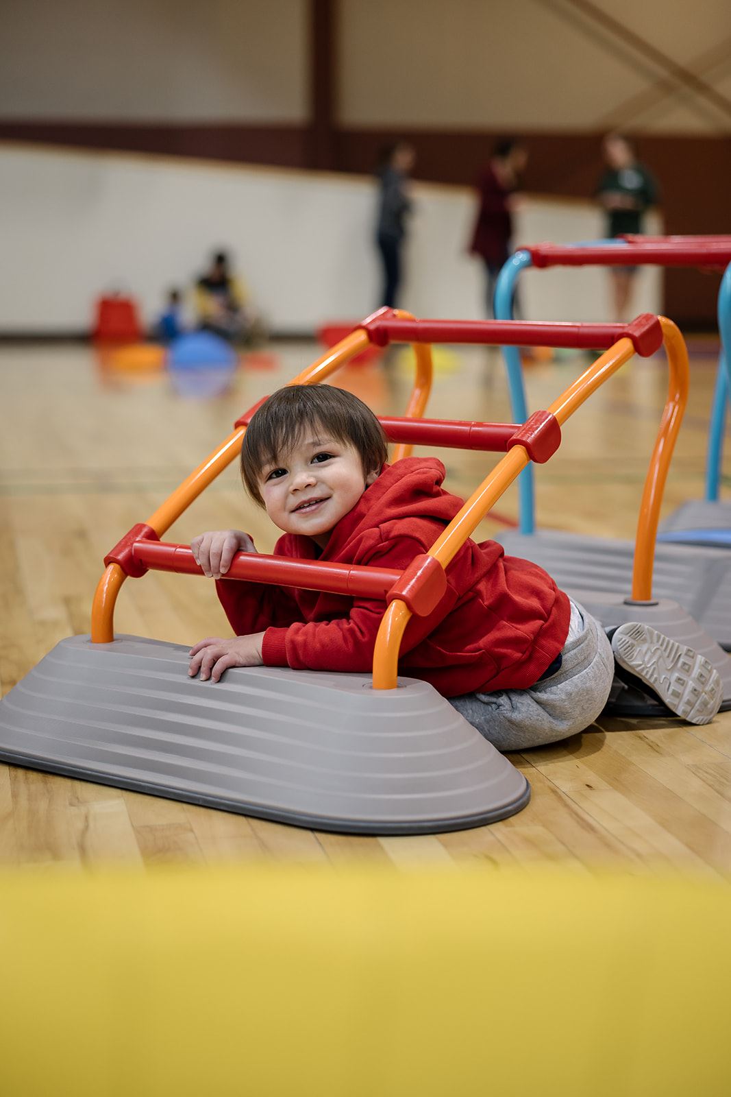 Child playing with play equipment in gym