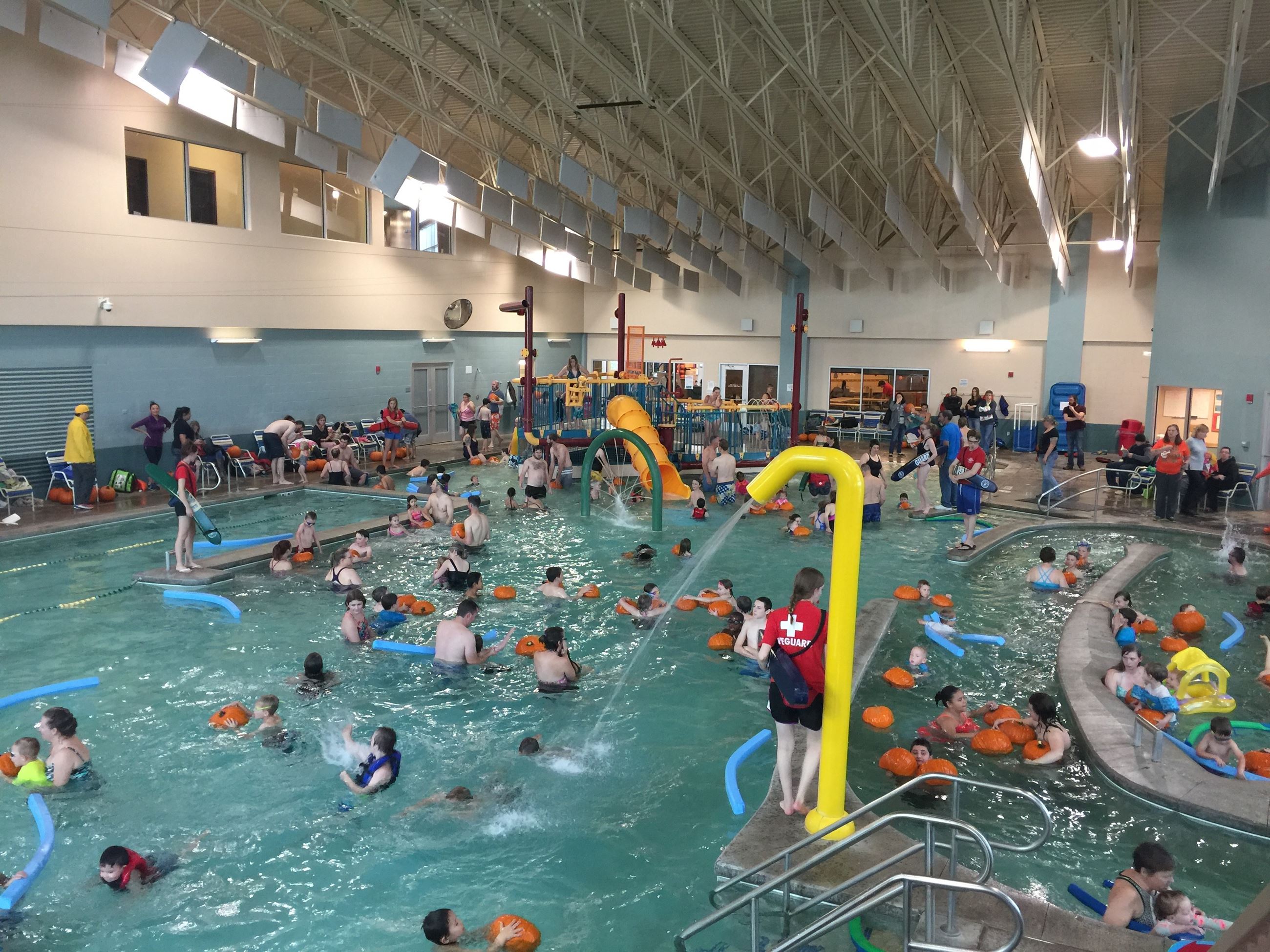 kids in pool with pumpkins